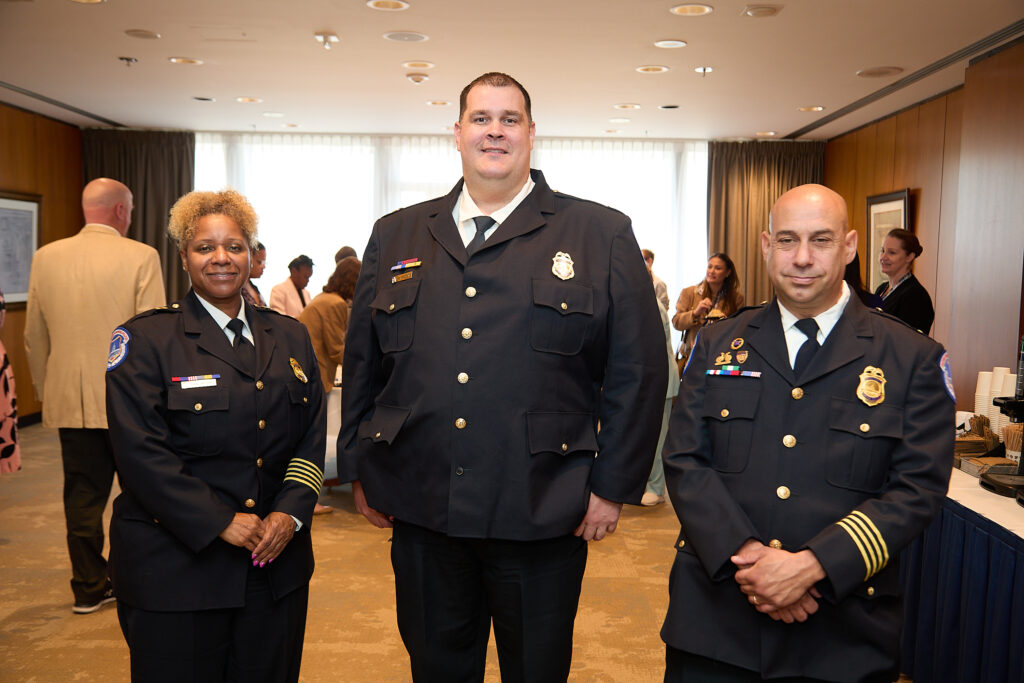 Three U.S. Capitol Police Officers stand together in their dress uniforms