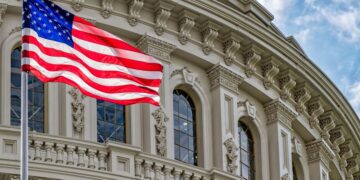 United States flag in front of the United States capitol building