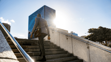 person with a laptop bag walking to work