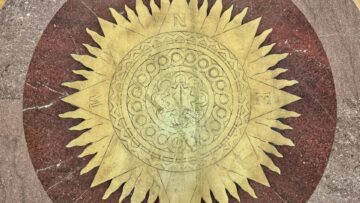 Compass with a sunburst motif on a marble floor