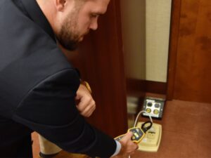 a person inspecting an electrical panel