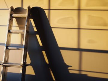 ladder against a building at sunset