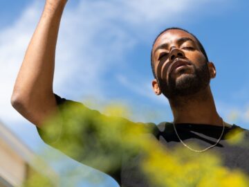 a person shielding the sun away with their hand