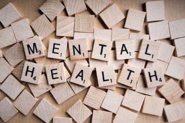 Scrabble tiles that spell out the words "Mental Health"
