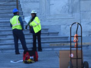 people in hard hats assessing a building on Capitol Hill